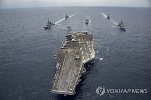 In this Associated Press photo provided by the U.S. Navy on April 28, 2017, USS Carl Vinson (C), a U.S. aircraft carrier, leads the Japan Maritime Self-Defense Force vessels during a joint exercise. (Yonhap)