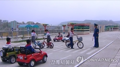 This still image, captured from video footage from North Korea's Korean Central TV on May 14, shows children taking part in traffic safety education at a traffic park in the city of Kanggye in North Korea's northern Jagang Province. (For Use Only in the Republic of Korea. No Redistribution) (Yonhap)