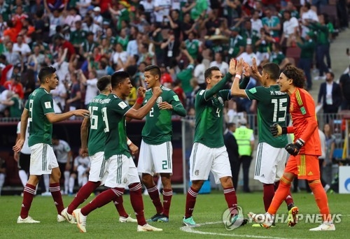 Mexico national football team players celebrate after defeating Germany 1-0 in their 2018 FIFA World Cup Group F match at Luzhniki Stadium in Moscow on June 17, 2018. (Yonhap)