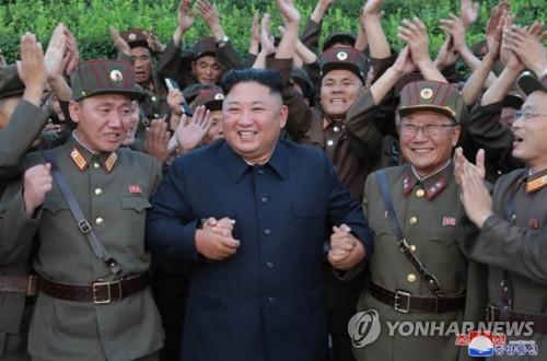 North Korean leader Kim Jong-un (C) celebrates with North Korean soldiers after watching the firing of "new-type tactical guided missiles" on Aug. 6, 2019, in this photo released by the North's official Korean Central News Agency (KCNA) on Aug. 7. Kim said this week's missile launches were an "adequate warning" against the joint military exercise between South Korea and the United States that kicked off earlier this week, the KCNA said. (For Use Only in the Republic of Korea. No Redistribution) (Yonhap)