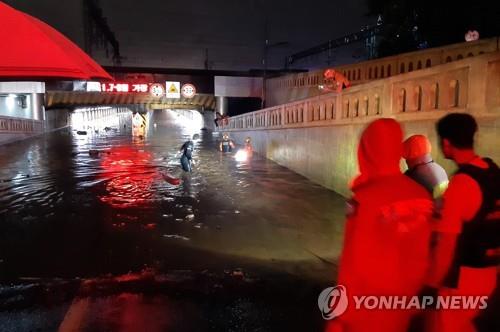 This photo, provided by the Busan Metropolitan Fire and Disaster Headquarters, shows rescue operations inside an underpass in the southern port city on July 23, 2020. (Yonhap) (No resales. No archiving)