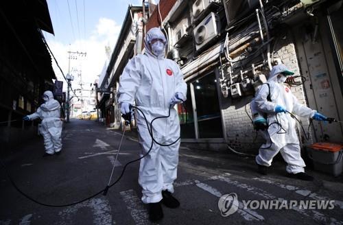 Volunteer workers disinfect a street in Itaewon in the central Seoul ward of Yongsan on May 12, 2020. (Yonhap)