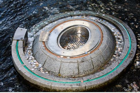 This photo, provided by the Seoul metropolitan government, shows coins tossed into a wishing well at Cheonggye Stream in the capital. (PHOTO NOT FOR SALE) (Yonhap)