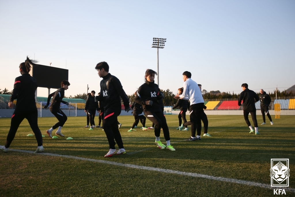 In this file photo provided by the Korea Football Association on Jan. 3, 2022, members of the South Korean women's football team warm up for a training session at Namhae Sports Park in Namhae, about 500 kilometers south of Seoul. (PHOTO NOT FOR SALE) (Yonhap)