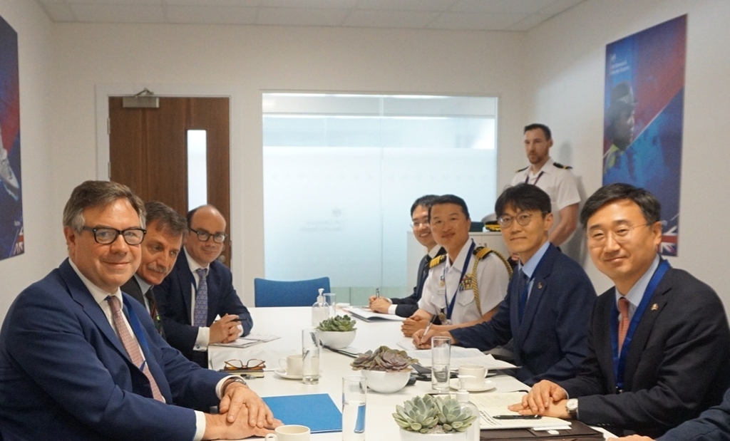 South Korea's Vice Defense Minister Shin Beom-chul (R) and Jeremy Quin (L), Britain's minister for defense procurement, pose for a photo as they meet for talks on the margins of a British air show on July 20, 2022, in this photo provided by Seoul's defense ministry. (PHOTO NOT FOR SALE) (Yonhap)