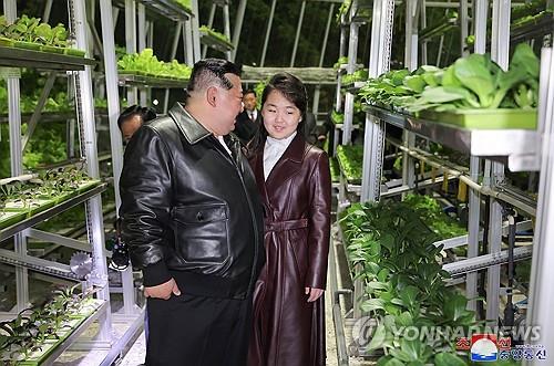North Korean leader Kim Jong-un (L) attends a ceremony alongside his daughter, believed to be named Ju-ae, to mark the completion of the Kangdong Greenhouse Farm in a Pyongyang suburb on March 15, 2024, in this photo carried by the North's official Korean Central News Agency the next day. (For Use Only in the Republic of Korea. No Redistribution) (Yonhap)