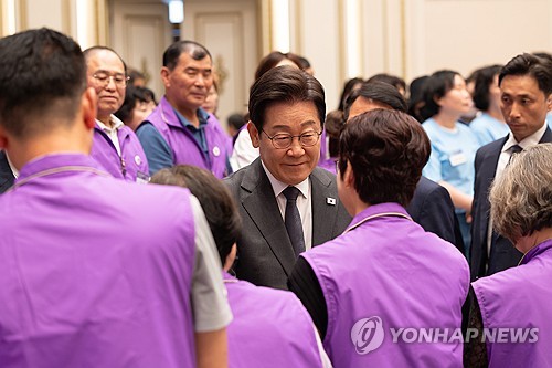 President Lee Jae Myung (C) meets family members of the victims of the 2022 crowd crush at Cheong Wa Dae in central Seoul, in this file photo taken July 16, 2025, and provided by his office. (PHOTO NOT FOR SALE) (Yonhap)