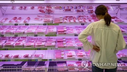 대형마트에서 돼지고기 살펴보는 여성 