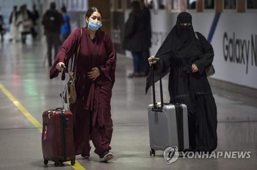 지난 3일(현지시간) 북아프리카 모로코의 카사블랑카 국제공항에서 승객들이 마스크를 쓰고 걷고 있다.[AFP=연합뉴스]