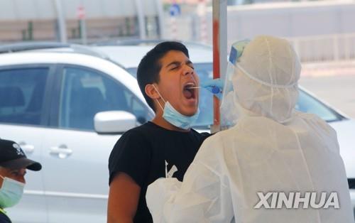 9일(현지시간) 이스라엘 중부 도시 로드에서 한 남성이 신종 코로나바이러스 감염증(코로나19) 검사를 받고 있다. [신화=연합뉴스]