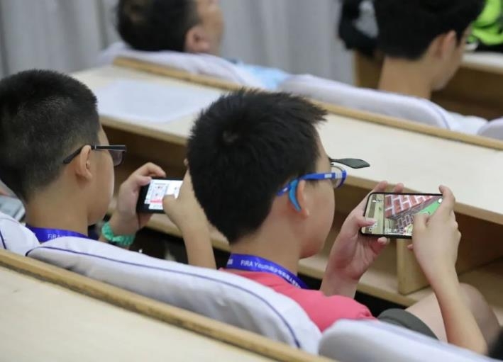 스마트폰으로 게임하는 중국 학생들