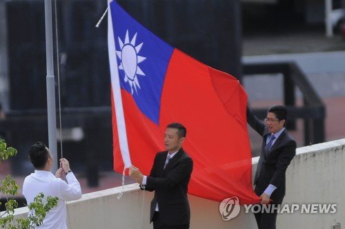 파나마가 단교를 선언한 13일 국기하강식을 하는 대만 대사관 직원들(EPA=연합뉴스)