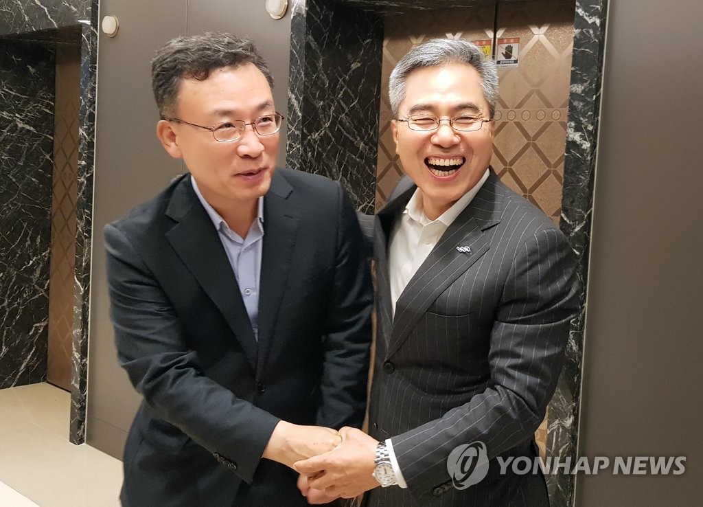 악수하는 하영구 은행연합회장과 심성훈 K뱅크 은행장