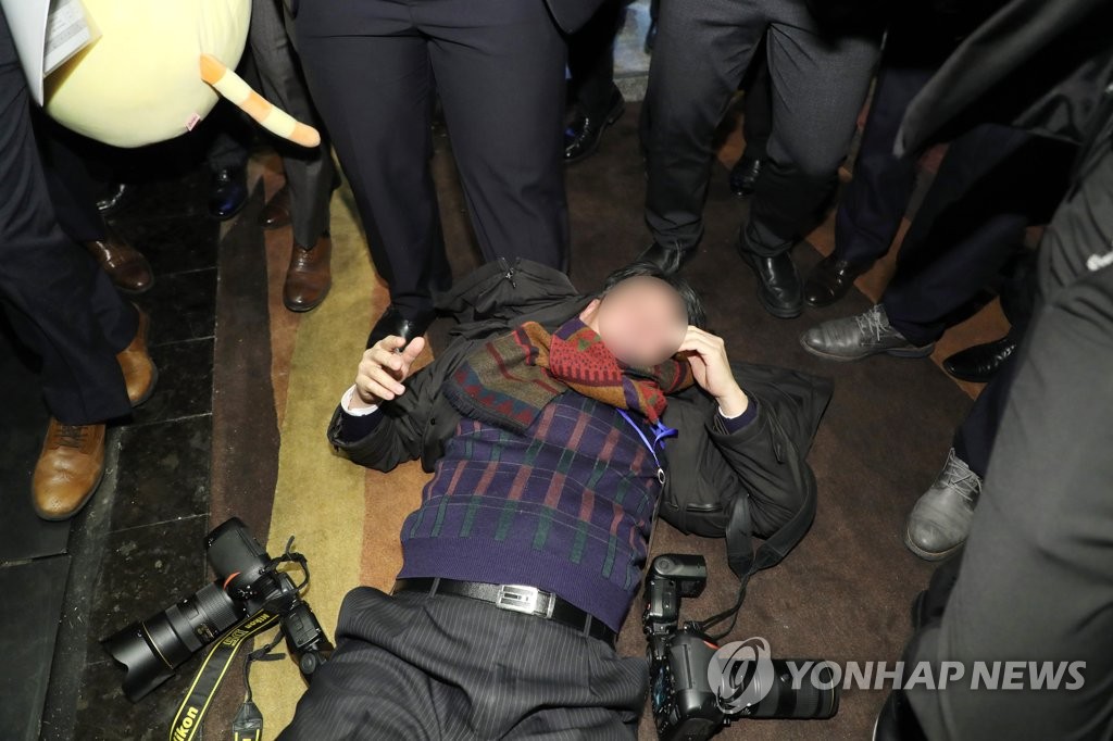 暴行を受けた韓国メディアのカメラマン。韓中の経済・貿易関連行事を取材中だった＝１４日、北京（聯合ニュース）