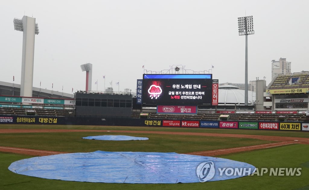 Tarps cover the home plate and the mound at KT Wiz Park in Suwon, 45 kilometers south of Seoul, on March 20, 2019, after a Korea Baseball Organization preseason game between home team KT Wiz and the LG Twins was called off during the bottom of the fifth inning.