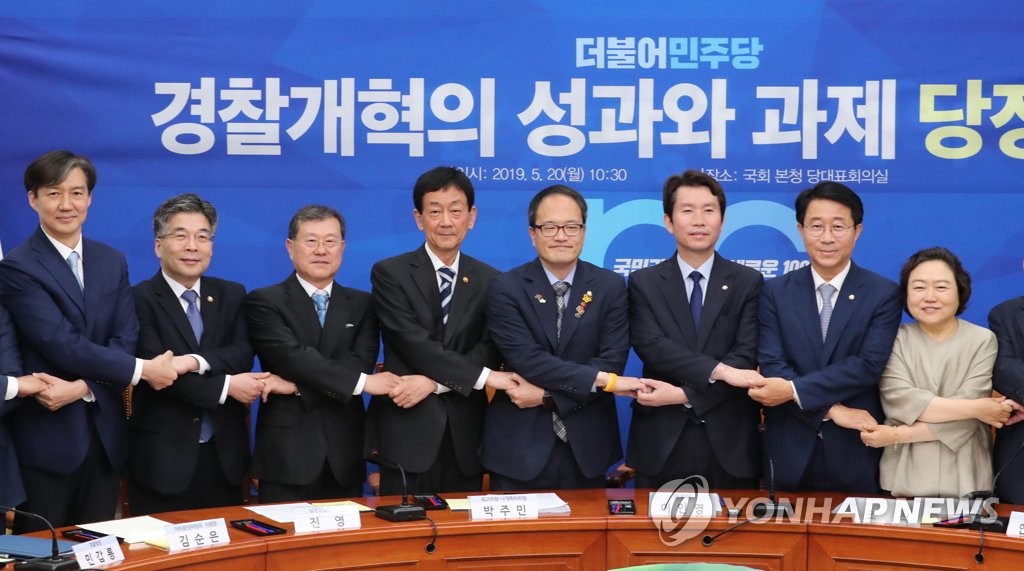 Cho Kuk (L), senior presidential secretary on civil affairs, and National Police Agency Commissioner General Min Gap-ryong (2nd from L) and officials from the ruling party and the government pose for a photo on May 20, 2019, ahead of their meeting to discuss ways for police reform at the National Assembly. (Yonhap)