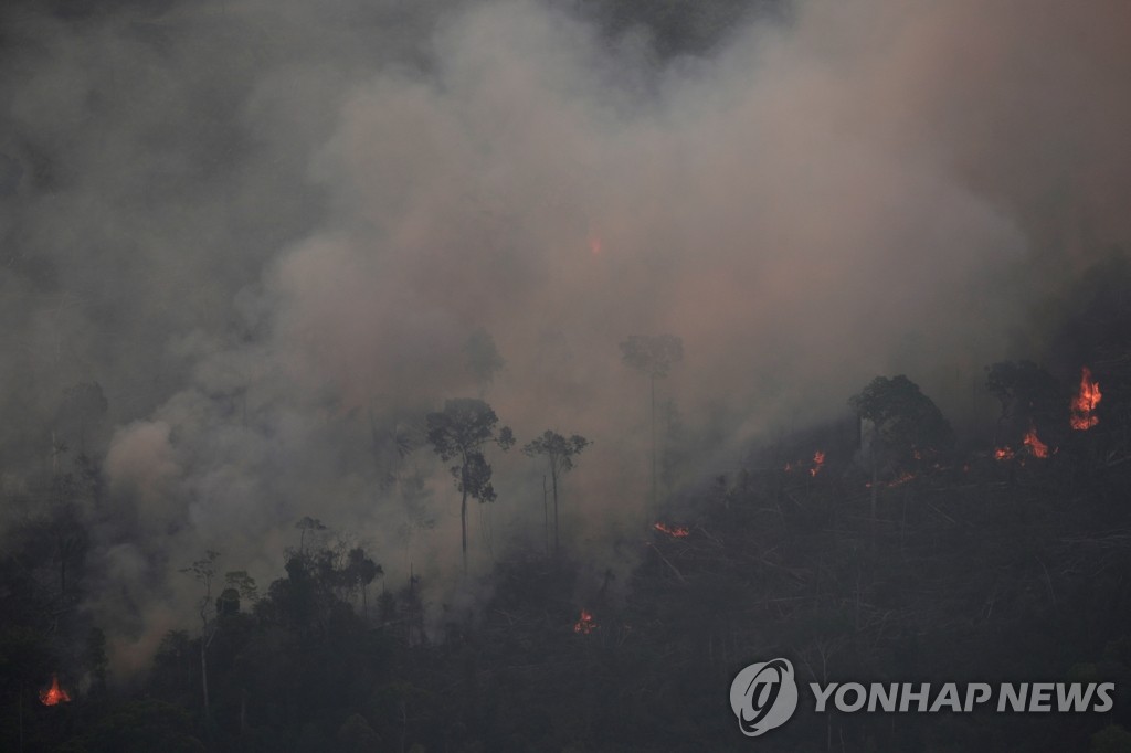 2019년 8월 21일 브라질 혼도니아주 포르투베유 인근의 아마존 우림지역에서 산불이 발생해 연기가 하늘을 뒤덮고 있다. [로이터=연합뉴스]