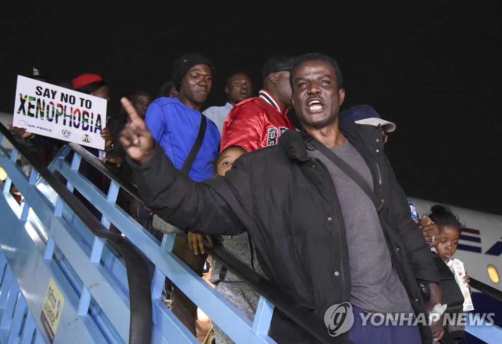 모국 공항 도착한 남아공 탈출 나이지리아인들