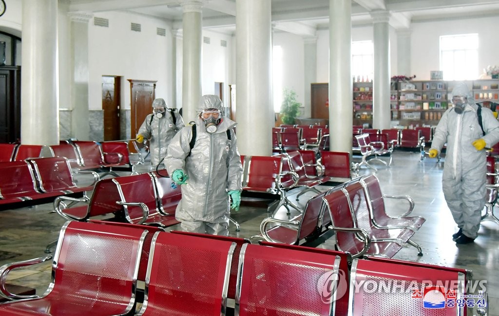People in protective clothing sterilize an unidentified facility in North Korea to keep the new coronavirus from spreading, in this photo released by the Korea Central News Agency on Feb. 15, 2020. (For Use Only in the Republic of Korea. No Redistribution) (Yonhap)