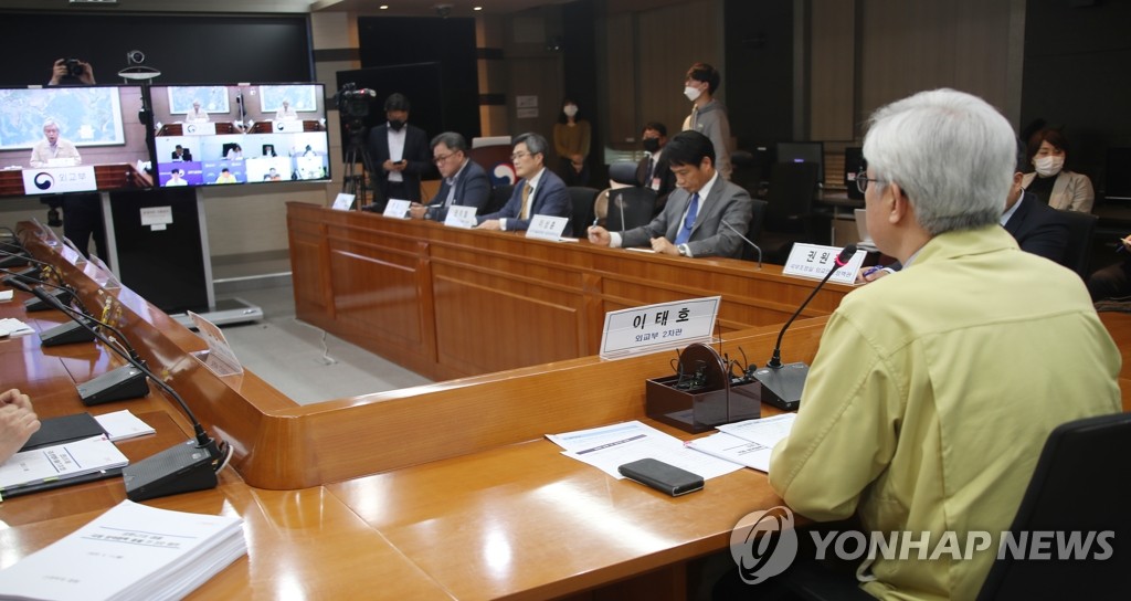 Second Vice Foreign Minister Lee Tae-ho (R) presides over an interagency meeting of government and health officials on international cooperation for coronavirus responses at Seoul's foreign ministry on May 11, 2020. (Yonhap)