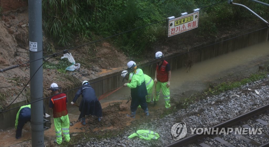 Train officials work to restore a rain-damaged railway in North Jeolla Province on Aug. 8, 2020. (Yonhap)
