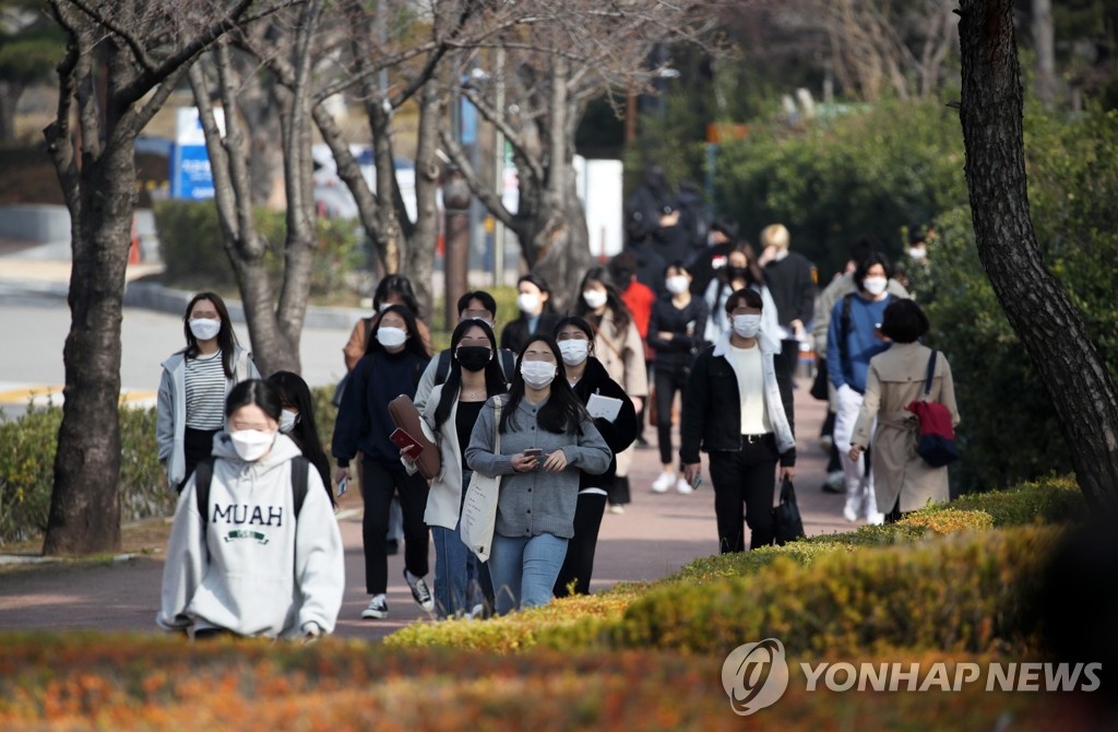 Students wearing masks walk around Chosun University's campus in Gwangju, 330 kilometers southwest of Seoul, on March 8, 2021. (Yonhap)