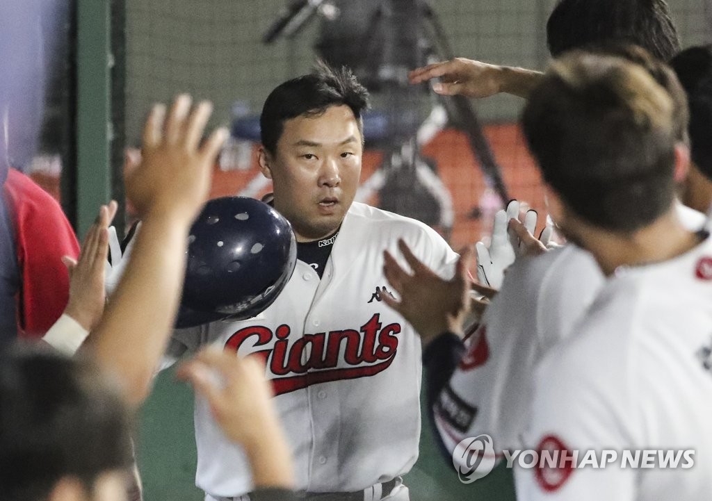 An Chi-hong of the Lotte Giants is greeted by teammates after hitting a solo home run against the Samsung Lions during the bottom of the fourth inning of a Korea Baseball Organization regular season game at Sajik Stadium in Busan, 325 kilometers southeast of Seoul, on Aug. 25, 2022. (Yonhap)