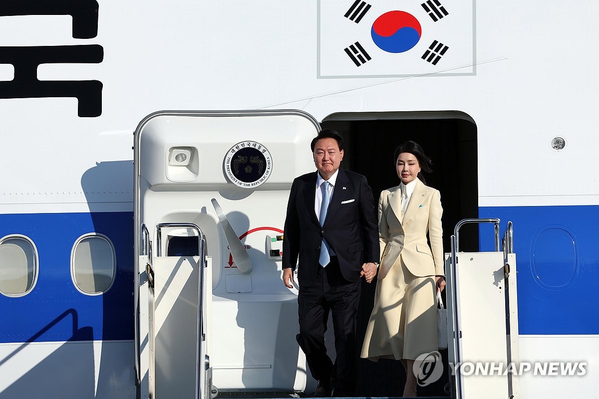 President Yoon Suk Yeol (L) and first lady Kim Keon Hee arrive at Astana International Airport in the Kazakh capital on June 11, 2024. (Pool photo) (Yonhap)
