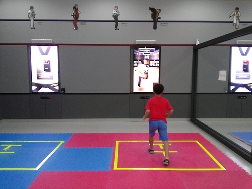 A kid experiences virtual sparring using a motion detection system in Taekwondowon in Muju, North Jeolla Province, on Aug. 27, 2016. (Yonhap)