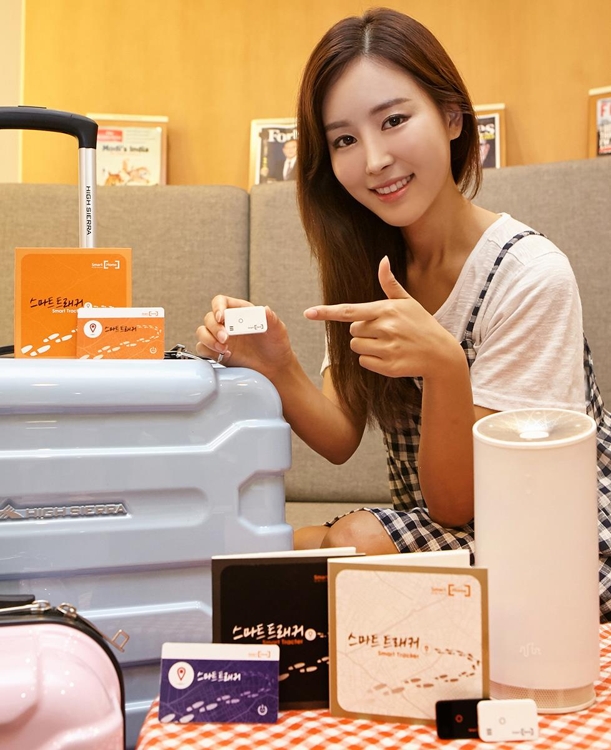A model poses for a photo with the Smart Tracker in this photo released by SK Telecom Co. on July 5, 2017. (Yonhap)