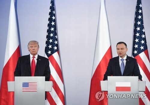 U.S. President Donald Trump holds a joint news conference with Poland's President Andrzej Duda in Warsaw on July 6. (EPA-Yonhap)