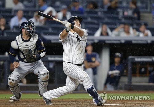 In this Associated Press photo, Choi Ji-man of the New York Yankees watches his two-run home run during the fourth inning against the Milwaukee Brewers at Yankee Stadium in New York on July 7, 2017. (Yonhap)