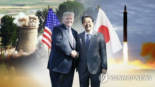 This image, provided by Yonhap News TV, shows U.S. President Donald Trump (L) and Japanese Prime Minister Shinzo Abe. (Yonhap)