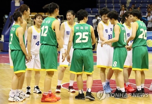 This pool photo taken July 4, 2018, shows South Korean and North Korean women's basketball players shaking hands after their friendly game at Ryugyong Chung Ju-yung Gymnasium in Pyongyang. (Yonhap)