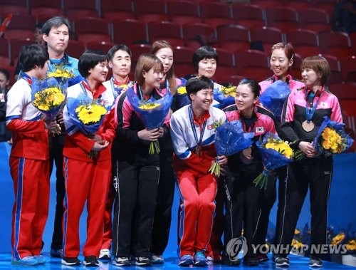 In this photo taken by the Korea Table Tennis Association on May 5, 2018, members of the unified Korean women's table tennis team pose for pictures wearing the bronze medals they won at the World Team Table Tennis Championships at Halmstad Arena in Halmstad, Sweden. (Yonhap)