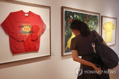 A visitor looks at works by Spanish artist Coco Capitan at the Daelim Museum in Seoul on Aug. 1, 2018. (Yonhap)