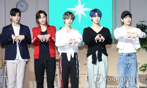 TXT members pose for photos during the showcase in Seoul of its second album titled "The Dream Chapter: Magic" on Oct. 21, 2019. (Yonhap)