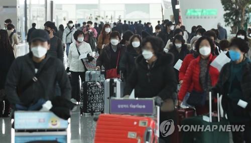 This undated file photo shows masked travelers arriving at Incheon International Airport, west of Seoul. (Yonhap)