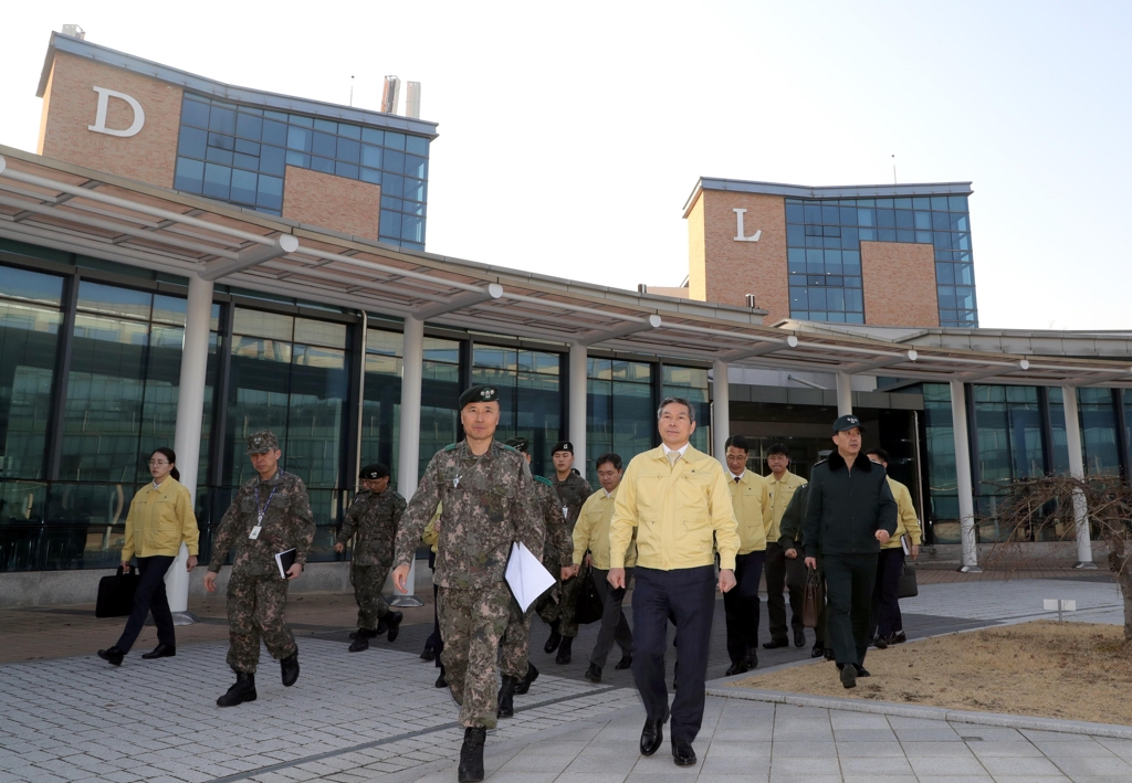 Defense Minister Jeong Kyeong-doo (front, R, wearing yellow jacket) looks around the Korea Defense Language Institute in Icheon, 80 kilometers southeast of Seoul, on Feb. 10, 2020, after the institute was chosen as a facility for a two-week stay for some 150 South Koreans and their Chinese family members who will be brought back from the coronavirus-stricken Chinese city of Wuhan via a third evacuation flight this week. (Yonhap)