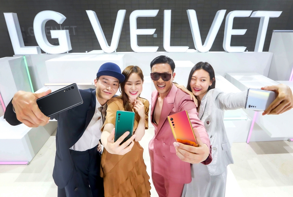 In this photo provided by LG Electronics Inc. on May 7, 2020, models introduce the company's new smartphone, LG Velvet, at its launching event in Seoul. (Yonhap)