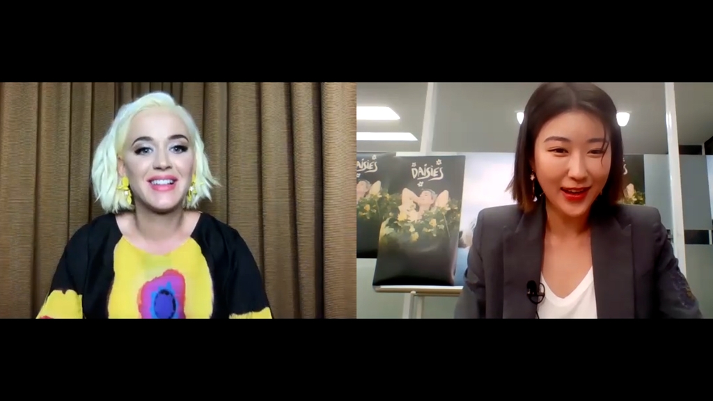 A screen grab of Korea Now's exclusive interview with American pop singer Katy Perry (L), conducted over the videoconference software Zoom on May 28, 2020. Perry was interviewed by Yonhap News' Korea Now host and creator, the Korean Unnie Moon So-hyun. (Yonhap)