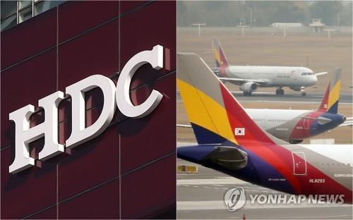HDC's company logo and Asiana Airlines' planes at an airport in South Korea (Yonhap)