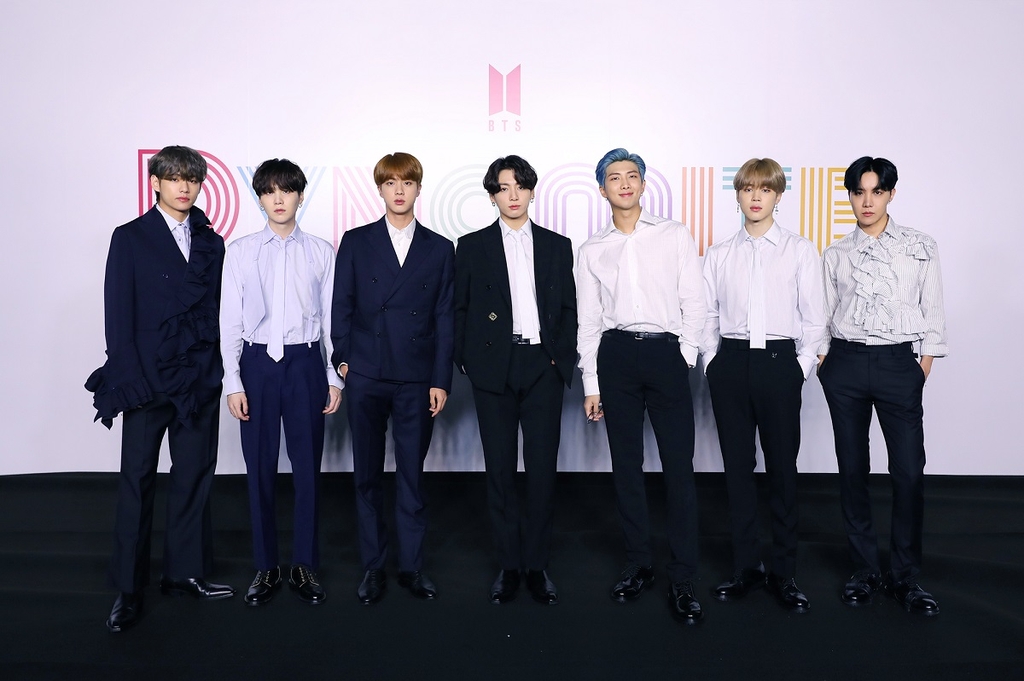 In this photo provided by Big Hit Entertainment, members of K-pop sensation BTS pose for photos during an online press conference for the new single "Dynamite" held in Seoul on Aug. 21, 2020. (PHOTO NOT FOR SALE) (Yonhap)