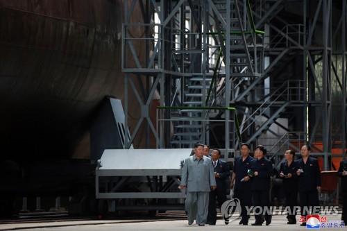 This file photo, released by the Korean Central News Agency on July 23, 2019, shows North Korean leader Kim Jong-un (L) inspecting a newly built submarine. As is customary, the agency did not provide the date and location. (For Use Only in the Republic of Korea. No Redistribution) (Yonhap)