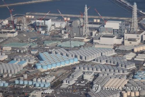 This AFP photo taken on Feb. 14, 2021, shows an aerial view of the Fukushima Daiichi Nuclear Power Plant undergoing decommissioning work and tanks for storing treated water. (Yonhap)
