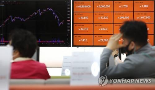 This file photo shows screens displaying the prices of cryptocurrencies at local cryptocurrency exchange Bithumb's office in southern Seoul. 
