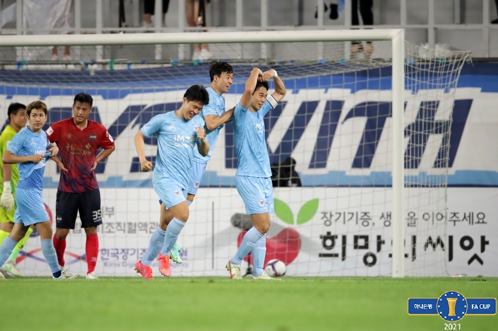 In this Aug. 11, 2021, file photo provided by the Korea Football Association, Kim Jin-hyeok of Daegu FC (R) celebrates his goal against Gimcheon Sangmu, during the clubs' quarterfinal match at the FA Cup at DGB Daegu Bank Park in Daegu, about 300 kilometers southeast of Seoul. (PHOTO NOT FOR SALE) (Yonhap)