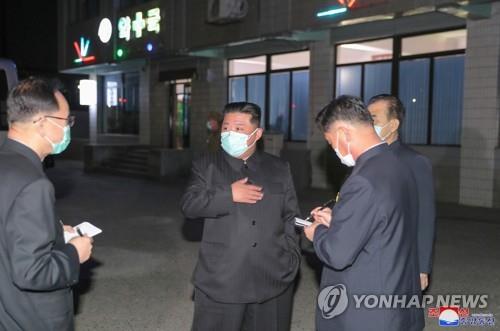 North Korean leader Kim Jong-un (C), wearing a face mask amid the COVID-19 outbreak, inspects a pharmacy in Pyongyang, in this undated photo released by the North's official Korean Central News Agency. (PHOTO NOT FOR SALE) (Yonhap)