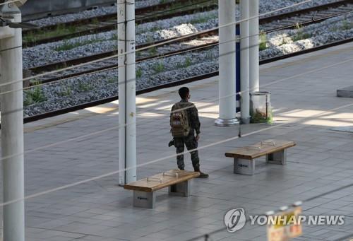 In this file photo, a service member waits for a train at Seoul Station in central Seoul on May 1, 2022. (Yonhap)