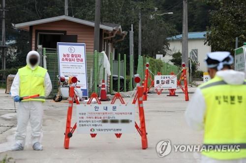 Quarantine officials block an entrance to a pig farm in Yanggu, 175 kilometers northeast of Seoul, as African swine fever broke out there. (Yonhap)